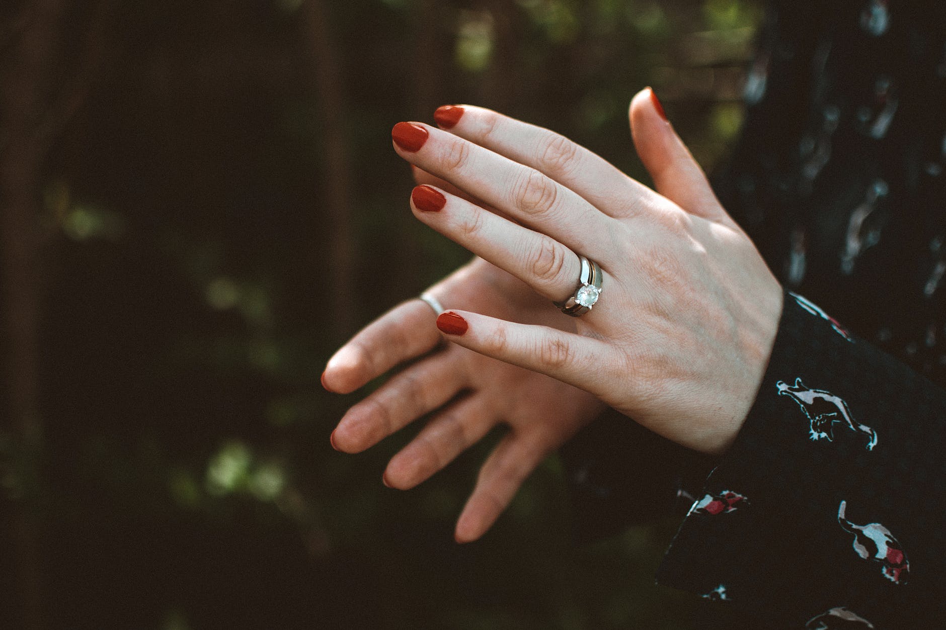 photo of person wearing silver diamond ring